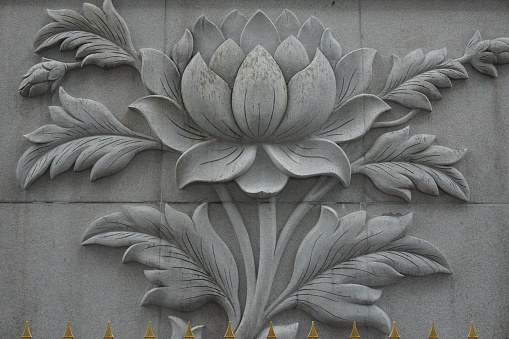 Big lotus flower carving on stone wall