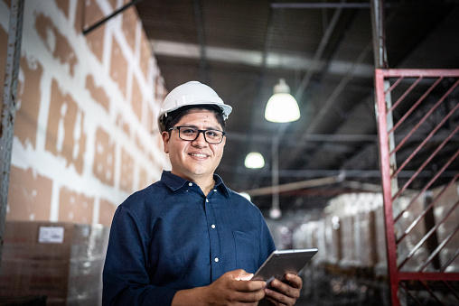 Portrait of a businessman using digital tablet in a warehouse