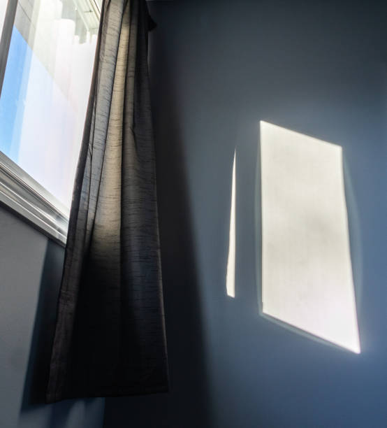 morning sunlight shining through open curtain window - illuminated vertical shadow focus on shadow imagens e fotografias de stock