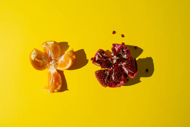 istock Open orange and pomegranate on yellow background 1473731984