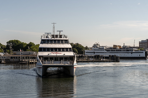 Hyannis Port, Massachusets- July 8, 2022: Hy-Line high speed ferry arrives in Hyannis Port after a trip to Marthas Vineyard with copy space