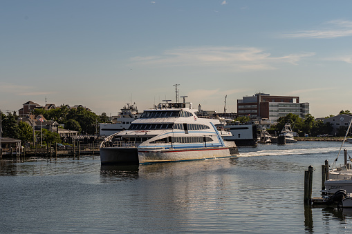 Hyannis Port, Massachusets- July 8, 2022: Hy-Line high speed ferry arrives in Hyannis Port after a trip to Marthas Vineyard with copy space.