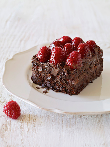 Chocolate cake slice with  raspberry topping