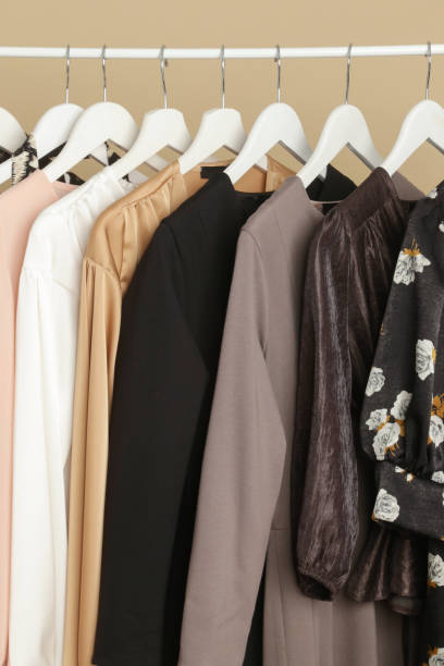 Women's Clothes. Clothes rack with stylish and elegant garments in fashion atelier. Good quality timeless fashion pieces. Women's Clothes. Clothes rack with stylish and elegant garments in fashion atelier. Good quality timeless fashion pieces. viscose stock pictures, royalty-free photos & images