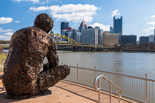 Pittsburgh, Pennsylvania, USA March 5, 2023 The Mr Rogers statue on the Allegheny River overlooking downtown Pittsburgh on a sunny winter day