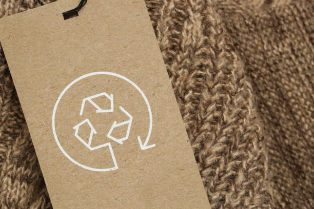 Close up of clothing tag with recycle icon. Recycling products concept. Zero waste, suistainale production, environment care and reuse concept. stock photo