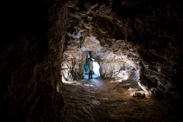 istock Adult Woman Exploring a Cave 1473739520