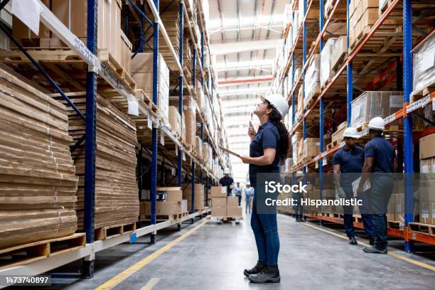 Warehouse Worker Doing An Inventory And Counting The Boxes Of Merchandise Stock Photo - Download Image Now