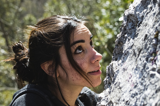 Girl rock climbing outdoor, female climber enjoy spring on crag