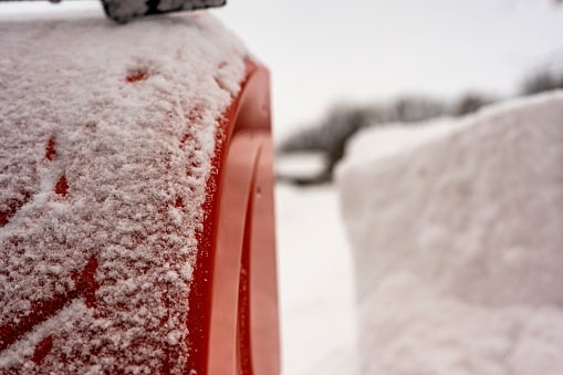 Selective focus on the side of a snow blower next to a drift. High quality photo