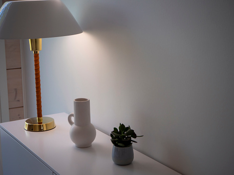 Stylish lamp and vase at the Housing Fair in Naantali, Finland 2022. High quality photo