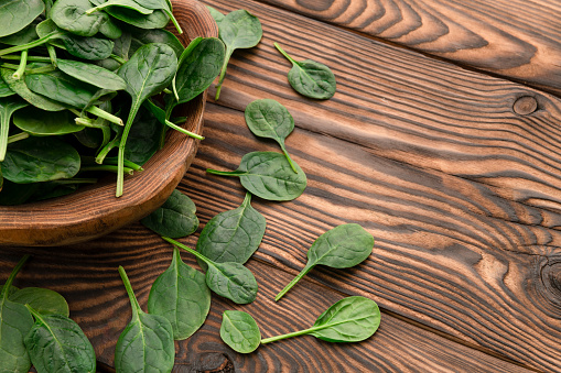 Spinach on wood table with space