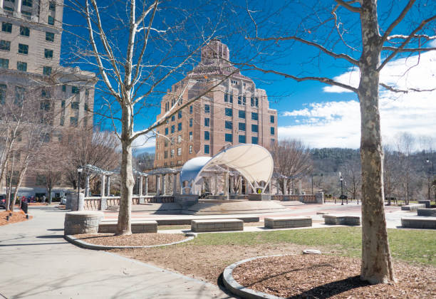 istock Pack Square Park with Performing Arts Stage and City Hall framed between two trees. . 1473749409