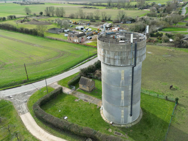 istock Drone view of a concrete water tower which has an array of 5G antennas on its circular roof. 1473749570