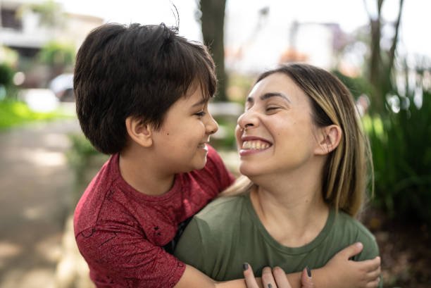 istock Mother and son embracing in a park 1473751213