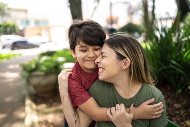 istock Mother and son embracing in a park 1473751230