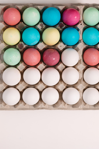 The egg carton contained a striking mix of half-dyed and half-white eggs.