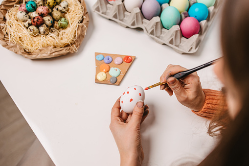 Painting Easter eggs with acrylic colours and brush