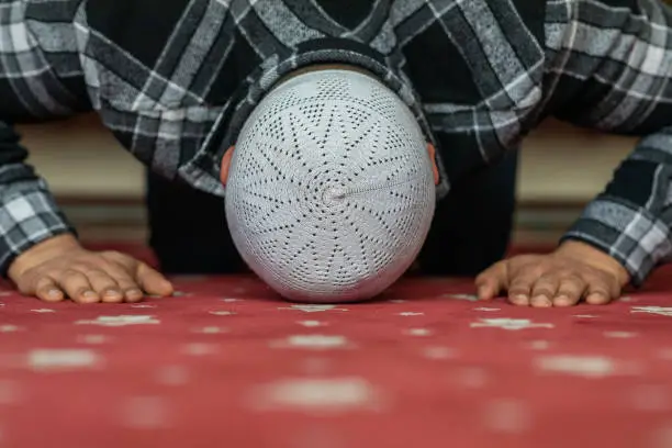 Photo of Man praying in mosque