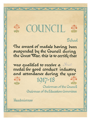 A certificate awarded to a school child by a British county council in recognition of “good conduct, industry and attendance during the year 1917-18” as the awarding of medals had been suspended “during the  Great War”. The recipient had qualified to receive a “First Medal”. (All identifying details have been removed.)