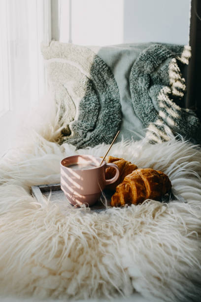 istock Cup of coffee with chocolate croissants on windowsill. 1473754848
