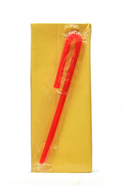istock Carton juice box with red plastic straw attached isolated on white background 1473759490