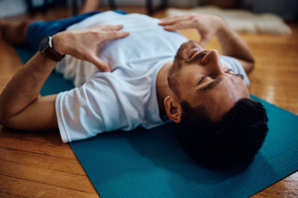 istock Exhausted sportsman resting on the floor during home workout. 1473762824
