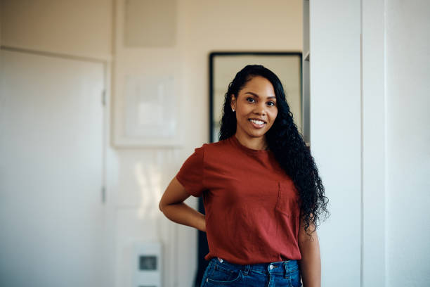 istock Young happy black woman at home looking at camera. 1473763338