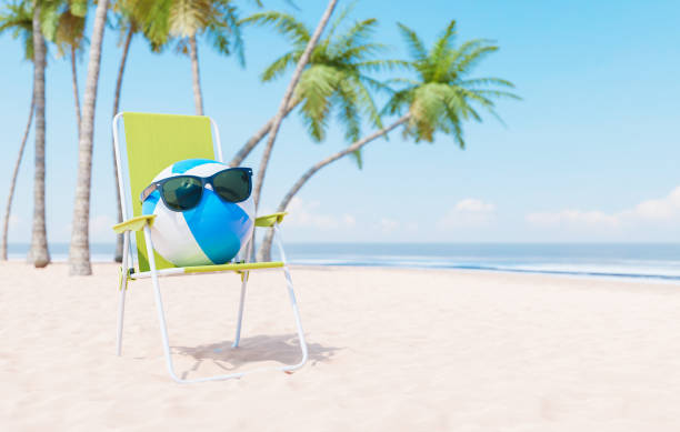 istock Beach chair with inflatable ball and sunglasses on sandy seashore 1473763892