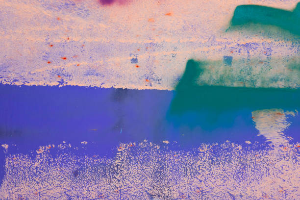 Messy paint strokes and smudges on an old painted wall background. Abstract wall surface with part of graffiti. Colorful drips, flows, streaks of paint and paint sprays Messy paint strokes and smudges on an old painted wall background. Abstract wall surface with part of graffiti. Colorful drips, flows, streaks of paint and paint sprays. purple graffiti metallic wall stock pictures, royalty-free photos & images