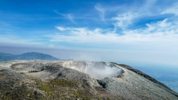 istock Seeing the inside of a volcano crater with smoke in east Java, Indonesia. 1473765234