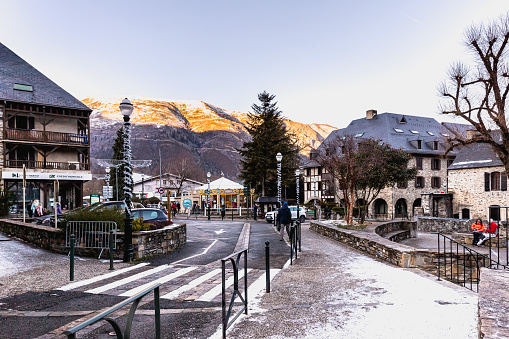 Saint-Lary-Soulan, France - December 26, 2020: Main street of famous ski resort where people are walking on a winter day
