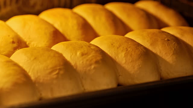 Buns for hot dog baking. Hot oven buns for hot dogs. Popular fast food.