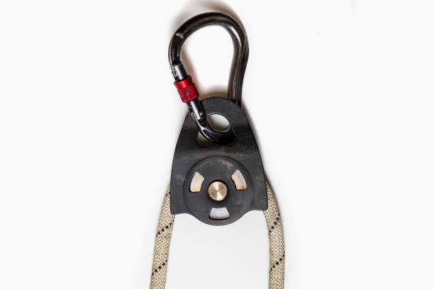 istock Roller block with carabiner and rope isolated on white background. Alpinism, high-altitude work. Equipment. 1473769190