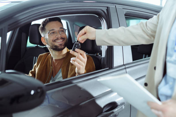 A young man buys a new car stock photo