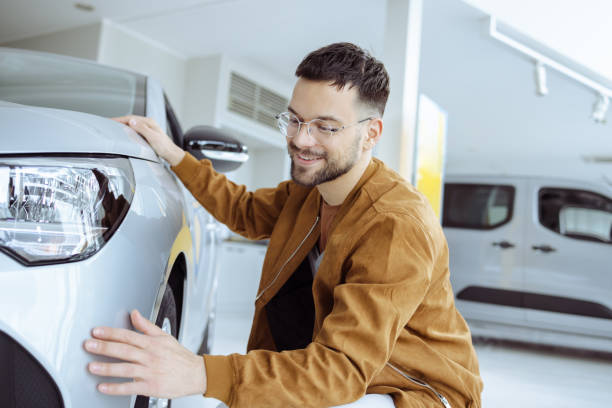istock Happy customer in a car showroom 1473772258