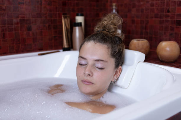 istock Young woman enjoying a bubble bath 1473773088