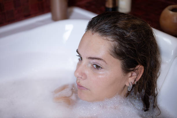 istock Young woman portrait enjoying a bubble bath 1473773145