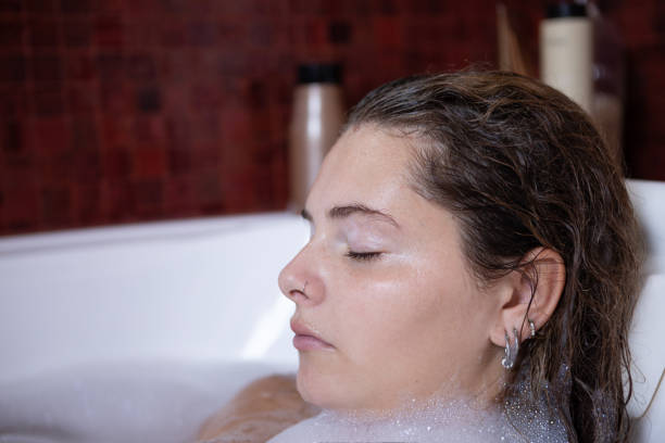 istock Young woman portrait enjoying a bubble bath 1473773152
