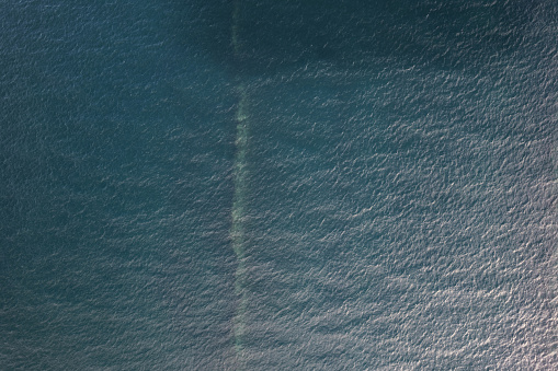Deep blue sea water texture wide drone above view