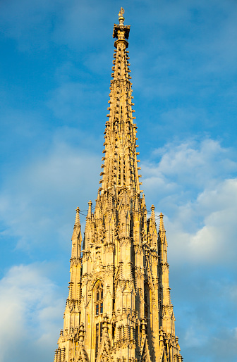 The view in a sunset light of 15th century Vienna's St. Stephen's Cathedral spire reaching 136 meters height (Austria).