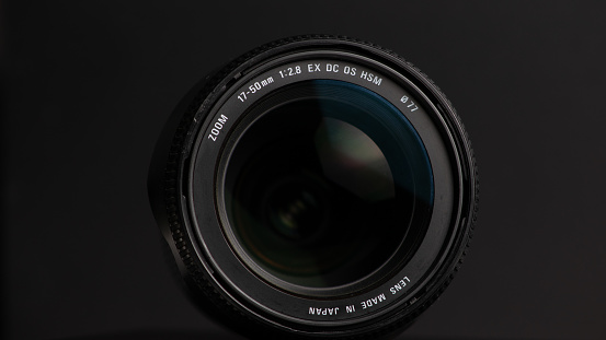 Camera lens on a black background. Close-up of a camera lens. Focus