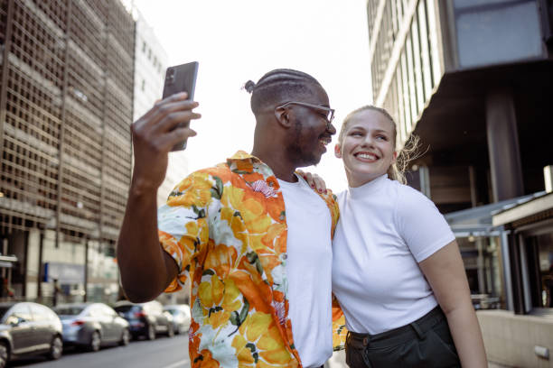 istock A smiling young man is taking a selfie with his girlfriend 1473781252