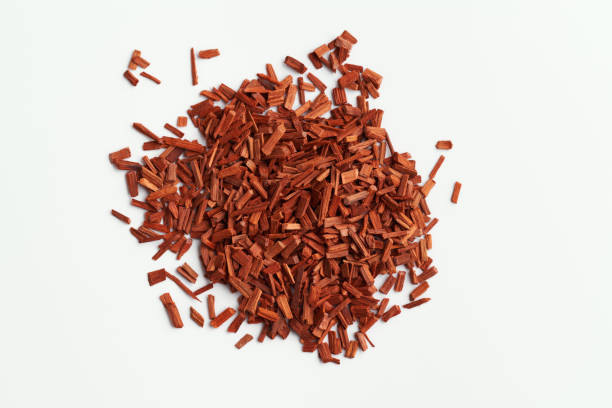 istock Red sandalwood chips on white background 1473781273
