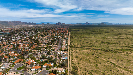 Aerial view of dividing line between land and developed suburbs in Scottsdale, Arizona.