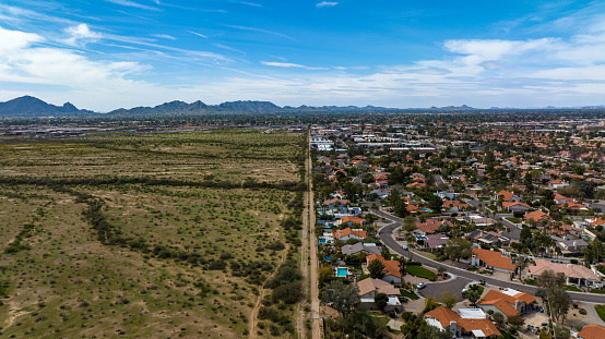 Aerial view of dividing line between land and developed suburbs in Scottsdale, Arizona.