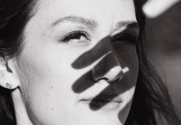 istock Close up of young woman shielding eyes 1473787603