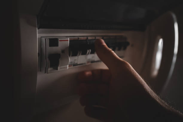 istock Male hand using fuse board relay. 1473788289