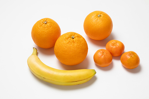 Oranges, Tangerines and a banana on white