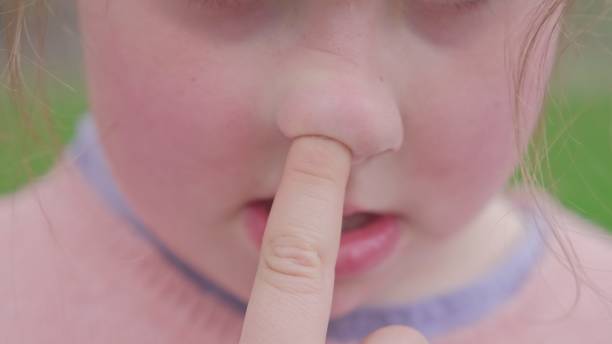 istock Young Caucasian Girl Picking Nose with Index Finger Front 1473794159